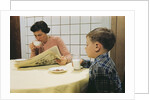 Boy Eating Cookies and Milk as Mom Reads by Anonymous