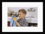 Boy Drying Serving Spoon by Anonymous