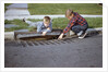 Boys Looking into Grate by Anonymous