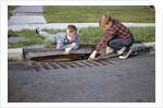 Boys Looking into Grate by Anonymous