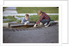 Boys Looking into Grate by Anonymous