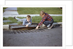 Boys Looking into Grate by Anonymous