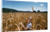 Boy Standing in Field of Wheat by Anonymous