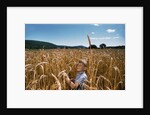 Boy Standing in Field of Wheat by Anonymous