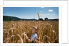 Boy Standing in Field of Wheat by Anonymous