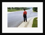Boy Waiting on Suburban Street by Anonymous