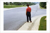 Boy Waiting on Suburban Street by Anonymous