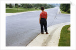 Boy Waiting on Suburban Street by Anonymous