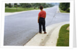 Boy Waiting on Suburban Street by Anonymous