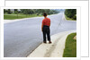 Boy Waiting on Suburban Street by Anonymous