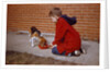Boy Feeding Dog on Sidewalk by Anonymous