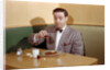 Businessman Pouring Syrup on Pancakes by Corbis