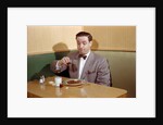 Businessman Pouring Syrup on Pancakes by Corbis