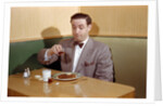 Businessman Pouring Syrup on Pancakes by Corbis