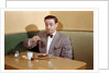 Businessman Pouring Syrup on Pancakes by Corbis