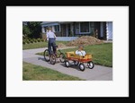 Boy Riding Tricycle and Towing Wagon by Anonymous