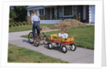 Boy Riding Tricycle and Towing Wagon by Anonymous