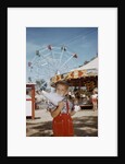 Boy Eating Cotton Candy at Fair by Anonymous