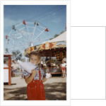Boy Eating Cotton Candy at Fair by Anonymous