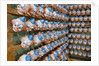 Clown Heads on Rack in Factory by Anonymous