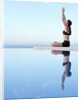 Woman Exercising on Swimming Pool Edge by Anonymous