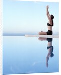 Woman Exercising on Swimming Pool Edge by Anonymous