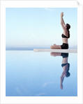 Woman Exercising on Swimming Pool Edge by Anonymous
