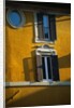 Shuttered Windows on Yellow Building by Anonymous