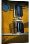 Shuttered Windows on Yellow Building by Anonymous