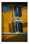 Shuttered Windows on Yellow Building by Anonymous