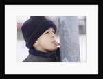 Boy Putting Tongue to Frozen Pole by Anonymous