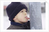 Boy Putting Tongue to Frozen Pole by Anonymous