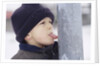 Boy Putting Tongue to Frozen Pole by Anonymous