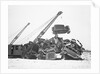 Crane Stacking Up Old Cars to be Burned in a Bonfire by Anonymous