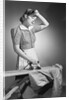 Woman Hard at Work Ironing by Anonymous