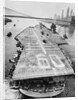 Huge Supercarrier Sailing Under Bridge by Anonymous