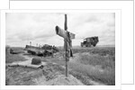 Ambulance Driving By Grave With Cross by Anonymous