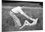 Young Couple Frolicking in Grass by Anonymous