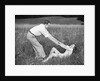 Young Couple Frolicking in Grass by Anonymous