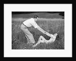 Young Couple Frolicking in Grass by Anonymous