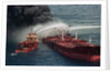 Boat Pours Water On Burning Oil Tanker by Anonymous