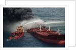 Boat Pours Water On Burning Oil Tanker by Anonymous