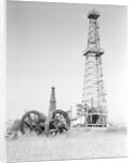 Oil Derricks In Field by Anonymous