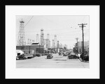 Clusters Of Oil Derricks Along Street by Anonymous