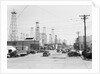 Clusters Of Oil Derricks Along Street by Anonymous