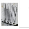 Variety Of Golf Clubs Lean Against Wall by Anonymous