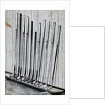 Variety Of Golf Clubs Lean Against Wall by Anonymous