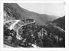 Train Traveling Over Viaduct in Mountain by Anonymous