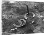 Horseshoes Around Pole by Anonymous