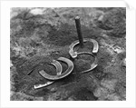 Horseshoes Around Pole by Anonymous
